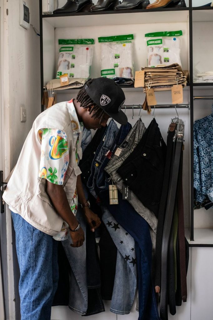 guy shopping his closet for clothes that can be upcycled
